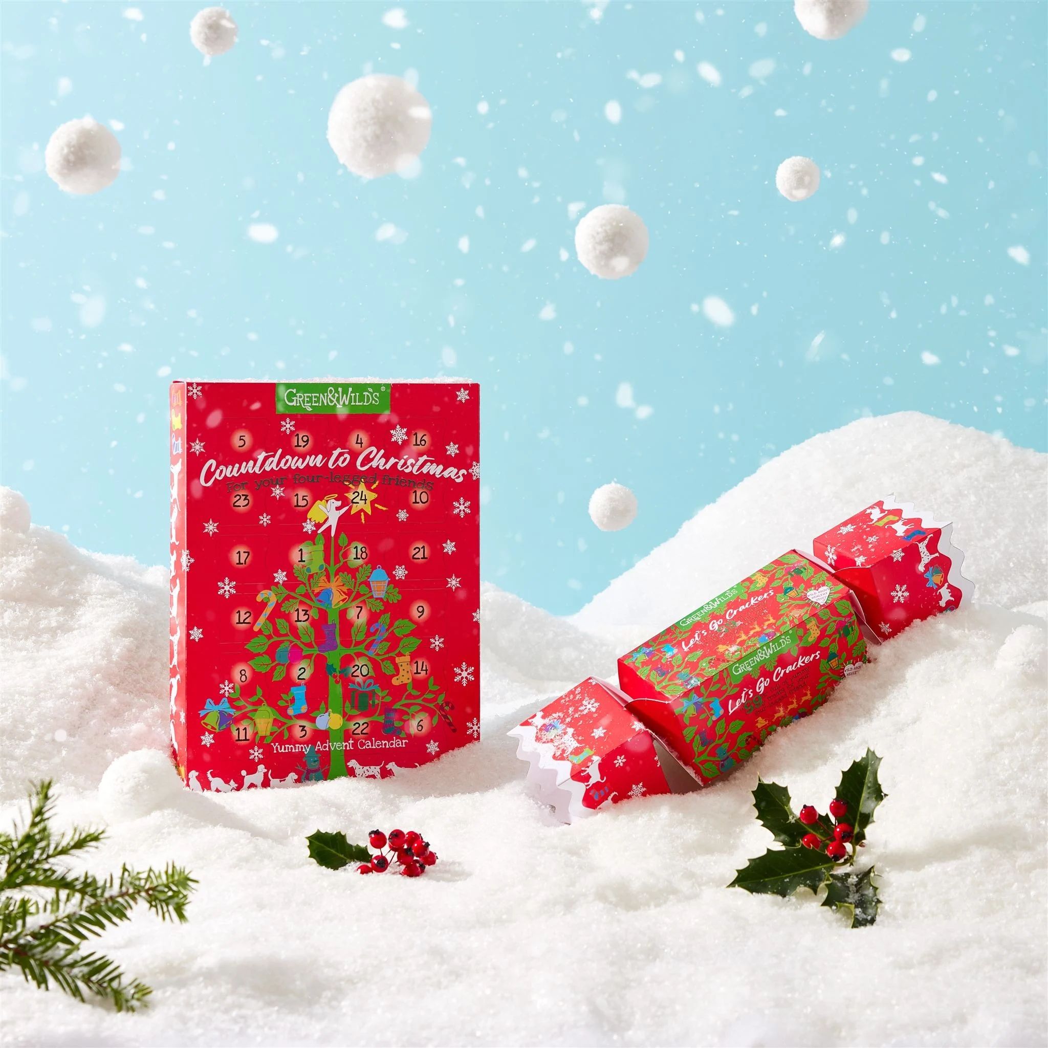 The Green and Wild's Advent Calendar shown paired with their Christmas Cracker on a snowy scene.